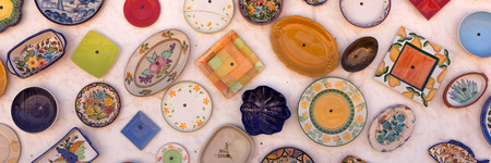 Colorful ceramic plates on the white wallの写真素材