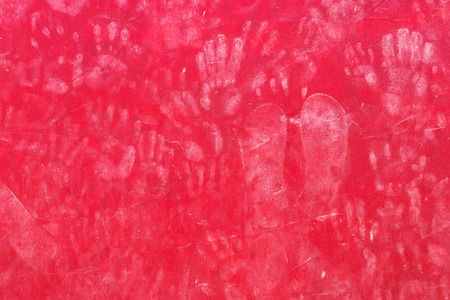 Background of hand prints on a red wallの写真素材