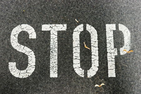 Stop sign on city asphalt on floorの写真素材