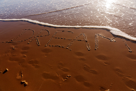 Dream word written in the sandy beachの写真素材