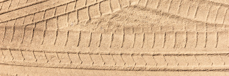 Tire tracks on the sand, sand textureの写真素材