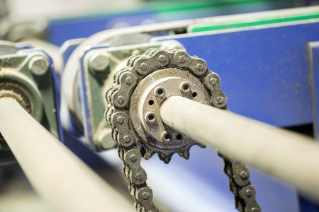 Closeup dirty ratchet gear with chain drive in metal processingの写真素材