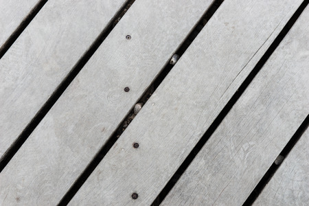 Old grey wood plank background at an angleの写真素材