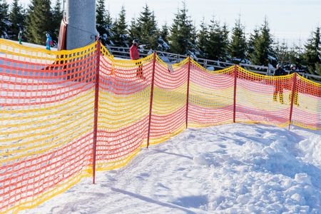 Plastic fence on the ski slope in winterの写真素材