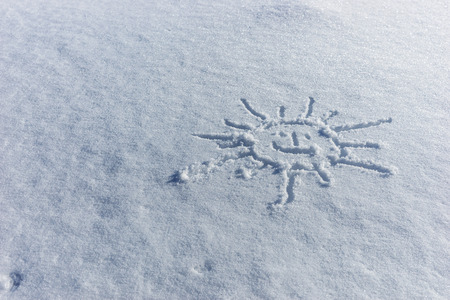 Sun drawn in the fresh white snowの写真素材