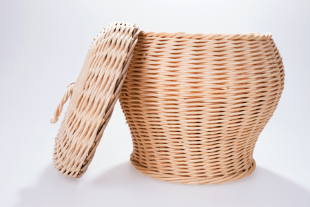 Round wicker basket with cover, isolated on whiteの写真素材