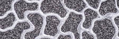 Gray stone wall surface with white irregular pattern