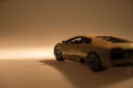 Yellow sports car illuminated with dark backgroundの写真素材