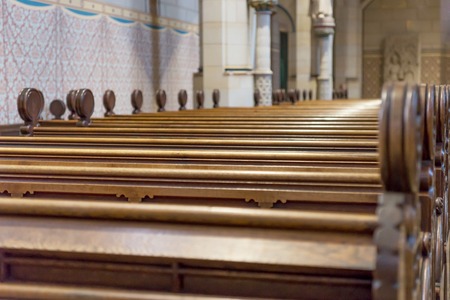 Empty wooden bench rows in the churchの写真素材