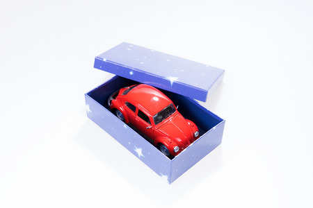 Red toy car in blue gift box