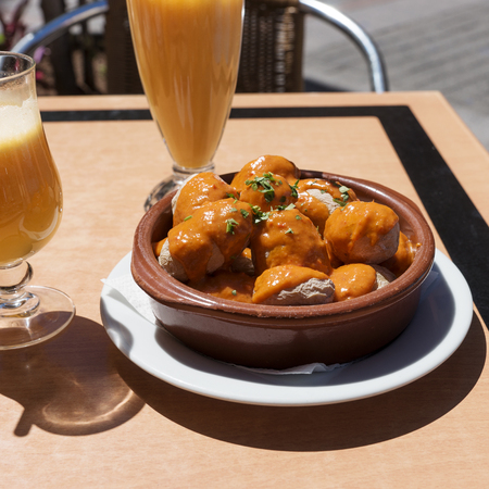 Canarian potatoes (boiled potatoes) with sauce on wooden tableの写真素材