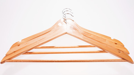 Three brown wooden hanger isolatedの写真素材