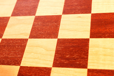Dark and bright squares of a brown wooden chess board