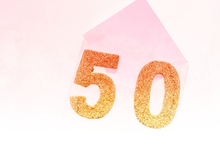 Golden number 50 on empty white letterの写真素材