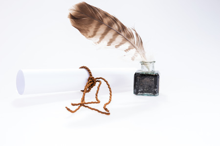 Empty white document and old writing feather in inkpotの写真素材