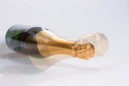 Lying new champagne bottle isolatedの写真素材