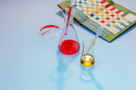 Glass laboratory apparatus with chemicals and book with periodic tableの写真素材
