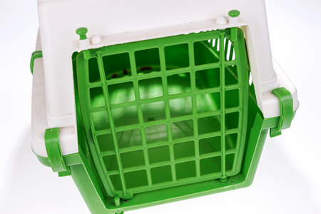 Closeup cat travel plastic cage in green and whiteの写真素材