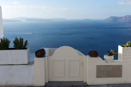 Closed white door overlooking the Mediterranean sea at Oia, Santoriniの写真素材