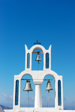 Church with three bells in the town of Fira Santoriniの写真素材
