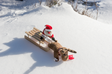 Drunk Santa Claus with empty bottle on the sledの写真素材