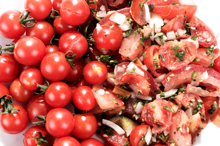 Tomatoes and tomato salad on the plateの写真素材