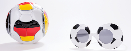 Football sport spectacles and soccer ball with German flag isolated on whiteの写真素材