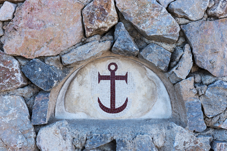 Closeup of anchor mosaic tiles on an old stone wallの写真素材