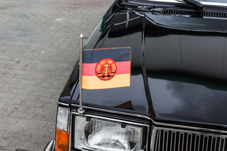 Flag of German Democratic Republic on a black carの写真素材