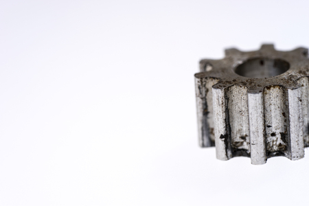 Silver old metal gear wheel isolated on whiteの写真素材