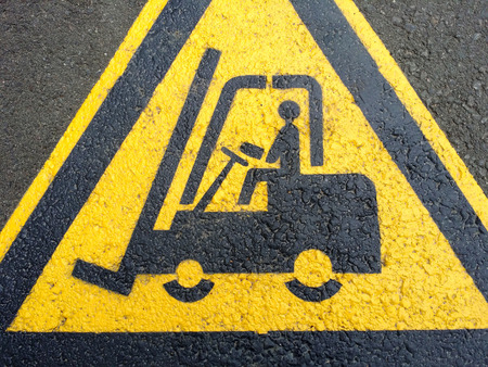 Forklift truck sign on the black asphaltの写真素材