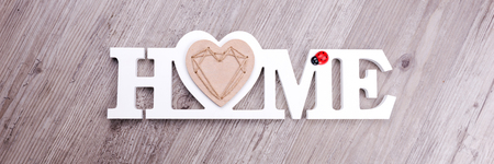 The word Home in white letters on dark wood backgroundの写真素材