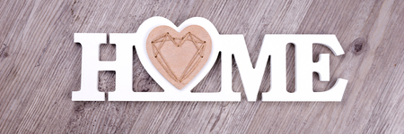 The word Home in white letters on dark wood backgroundの写真素材