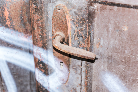 Fragment of old wooden door with rusty handleの写真素材
