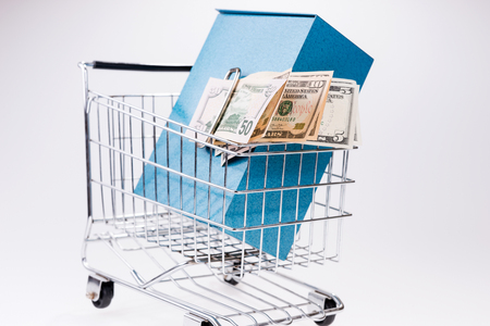 Shopping cart with bank safe box and dollar billsの写真素材