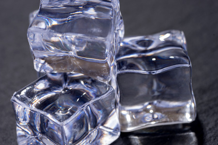 Three ice cubes isolated on black backgroundの写真素材