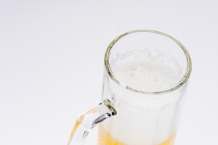 Big glass of beer isolated on a light backgroundの写真素材