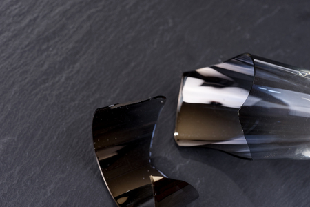 Broken champagne glass isolated on black backgroundの写真素材