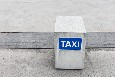 Reserved for taxi. Blue sign on concreteの写真素材