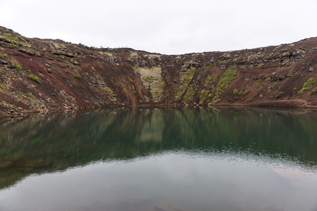 Reflection in the water of the volcano craterの写真素材