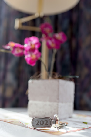 Hotel key number 202 on the table in the roomの写真素材