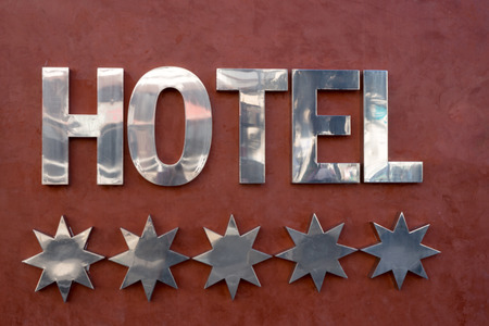 Five silver stars and hotel on brown background. The concept of rating. The rating of the hotel.の写真素材
