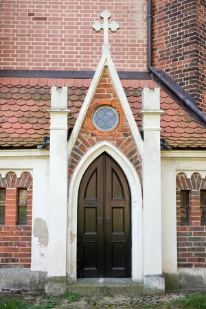 Old small wooden door of a churchの写真素材