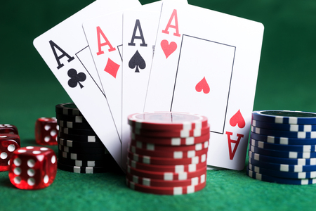 Poker chips, playing cards and red dice on green table. Casino gameの写真素材
