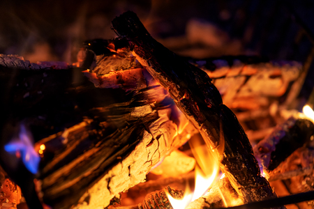 Firewood bonfire is blazing. Burning wood campfire in the night darknessの写真素材