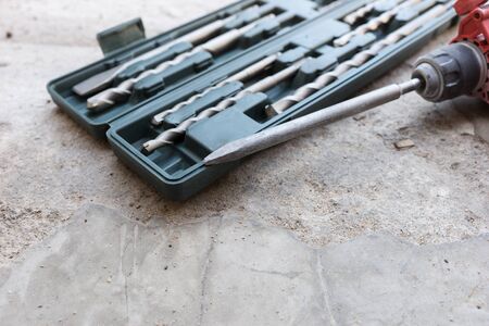 Impact drill with drill bits and chisel for concrete