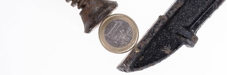 One euro coin in a black clamp isolated on white background. Panoramic pictureの写真素材