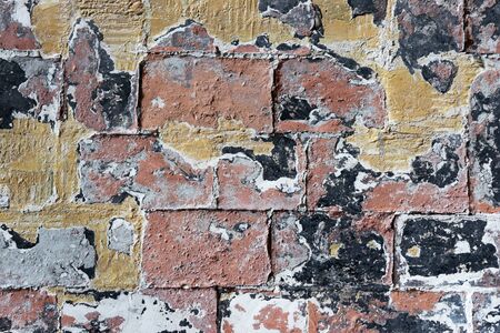 Old colorful worn brick wall background. Brick texture