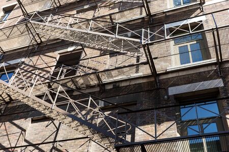 Fire escape stairs and ladders on a typical brick old building from Quebec, Canada