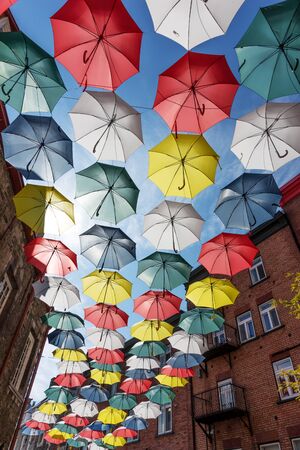 Colorful umbrellas in the sunshine. Rue du Cul-de-Sac, in the Quartier Petit Champlain, in Quebec Cityの写真素材